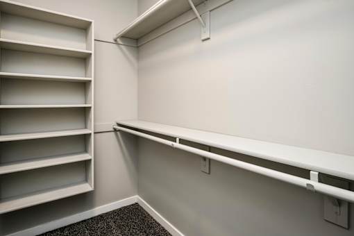 VUE 19 (Model 2Bd) - Closet with white shelving unit with multiple shelves is mounted on a white wall.