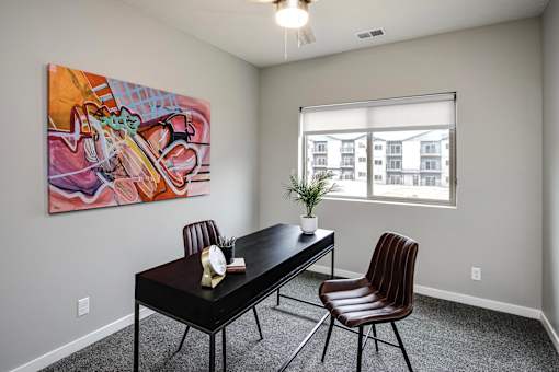 VUE 19 (Model 2Bd) - Spare room with a table, chairs and a painting on the wall.