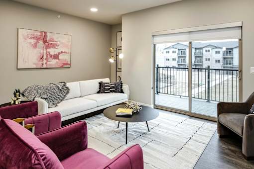 VUE 19 (Model 2Bd) - living room with a white couch, a coffee table, and a painting on the wall.