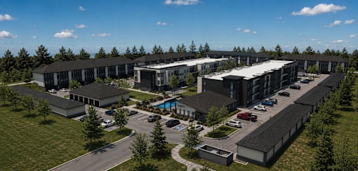A large, modern building complex with a parking lot in front.