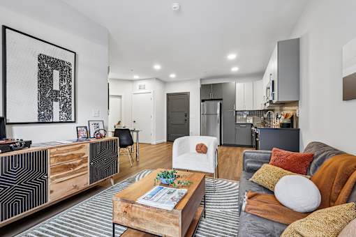 A modern living room with a grey couch and a wooden coffee table.