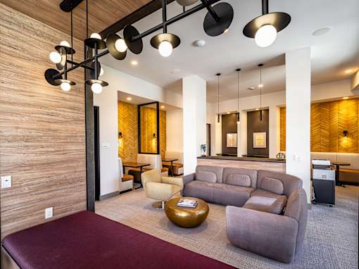 A modern living room with a dark wood floor and a white ceiling.