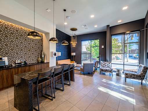 A modern lobby with a reception desk and chairs.