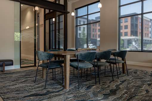A conference room with a long table and chairs.