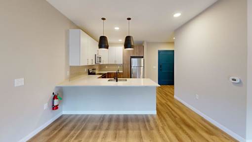 Open concept kitchen with island and pendant lighting at The Confluence Apartments, Easton, 18042