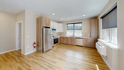 Open concept kitchen with stainless steel appliances at The Confluence Apartments, Easton