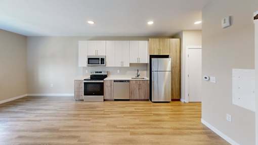 Open layout kitchen with stainless steel appliances at The Confluence Apartments, Pennsylvania