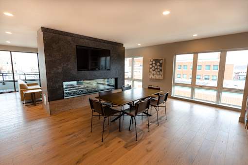 A modern living room with a fireplace and a television.
