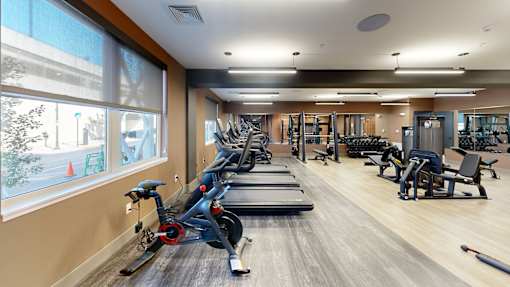 A gym with treadmills, elliptical machines, and other exercise equipment at The Standard Apartments, Pennsylvania, 18101