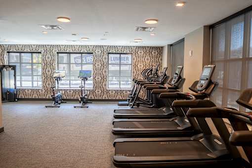 A gym with treadmills and elliptical machines at The Hive Apartments, Allentown, PA, 18101