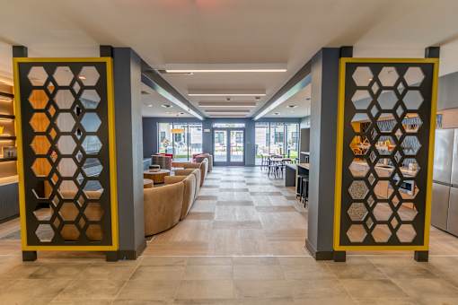 A hallway with a yellow and black gate divider at The Hive Apartments, Allentown, PA