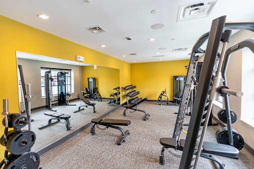 A gym with a variety of equipment including weights and cardio machines. at The Hive Apartments, Allentown, PA, 18101