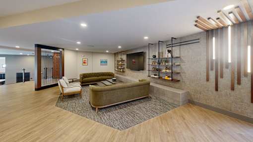 A modern living room with a green sofa and a wooden floor at The Standard Apartments, Allentown, 18101
