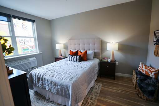 A bedroom with a large bed and a window.