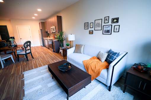 A living room with a white couch and a coffee table.