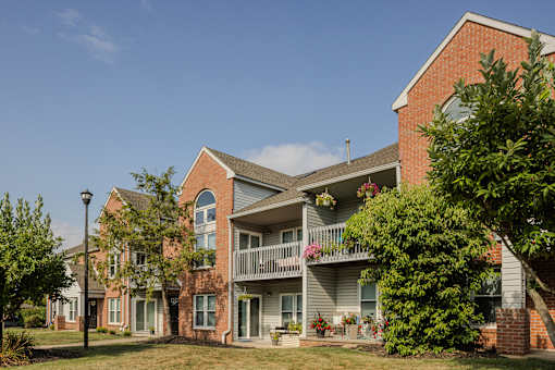 A red brick building with a balcony in the front. at Pointe North Apartments, Pennsylvania, 18017