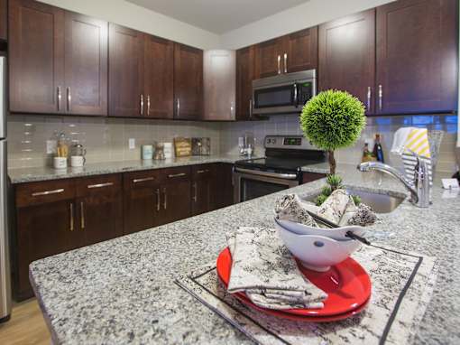 a kitchen with granite counter tops and wooden cabinets