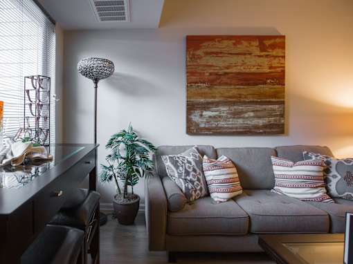 a living room with a couch and a painting on the wall