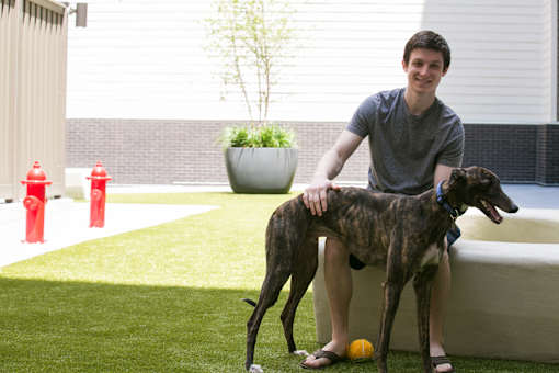 a man sitting on a couch with his dog