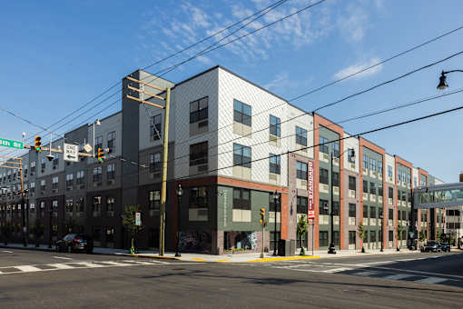 A street view of a multi-story building with a clear blue sky above.