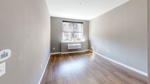 A room with a window and a radiator on the wall at The Standard Apartments, Pennsylvania