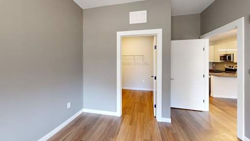 A room with a white door leading to a kitchen at The Standard Apartments, Allentown, PA, 18101