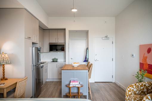 A kitchen with a refrigerator, microwave, and oven.at The Teale Golden Gate in Naples, FL, 34116