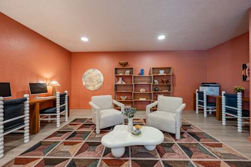 A living room with a white coffee table and a rug with a pattern of squares and rectangles.