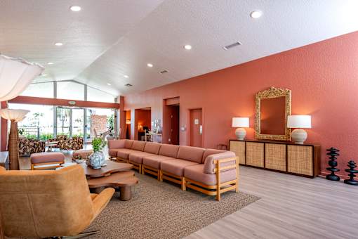 A living room with a brown sofa and a wooden coffee table.