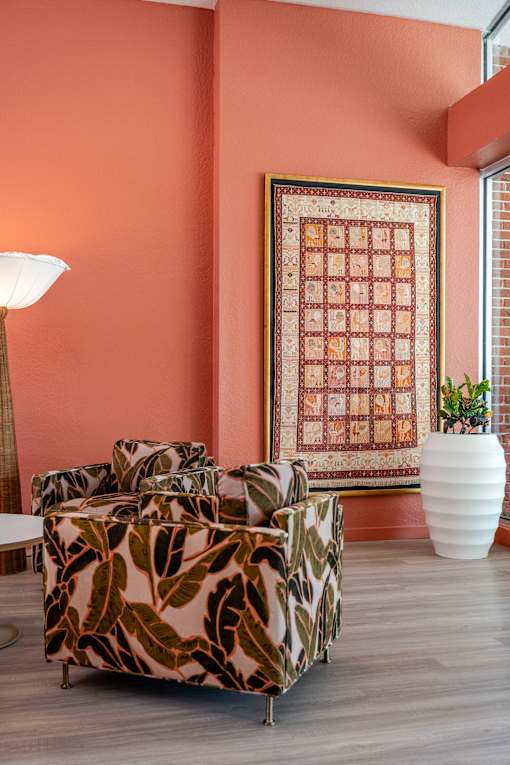 A living room with a sofa and a lamp.