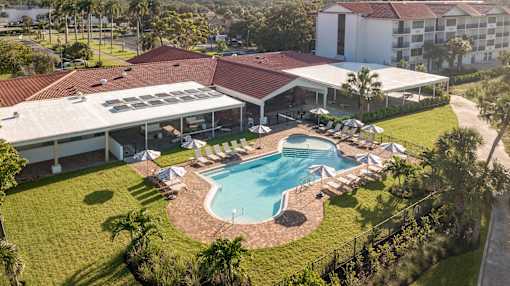 A large building with a pool in front.