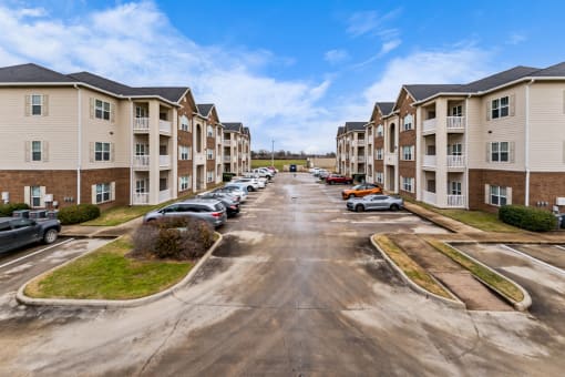 an empty parking lot in front of an apartment building