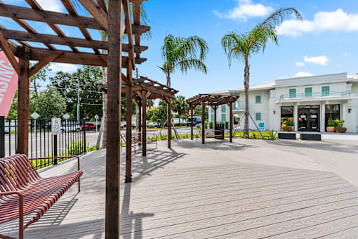 A wooden bench is on a wooden deck at The Teale Siesta Lago in Kissimmee, FL, 34746