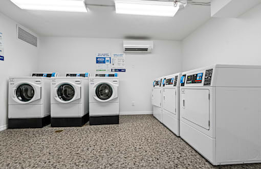 A row of washing machines in a laundromat at The Teale Siesta Lago in Kissimmee, FL, 34746