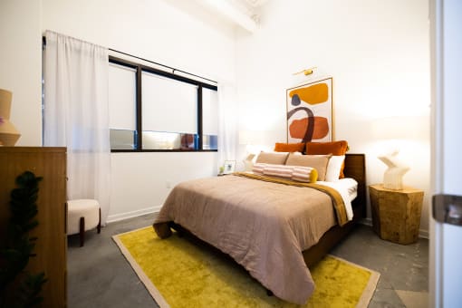 a bedroom with a bed and a large window  at The Lady, Columbia, SC