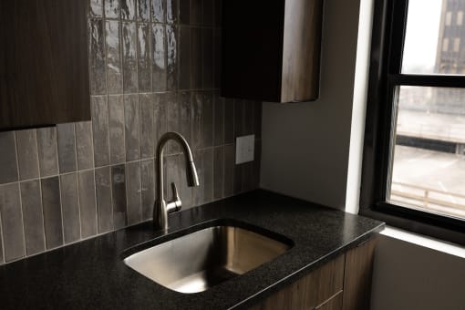a kitchen with a sink and a window  at The Lady, South Carolina