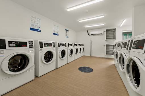 A row of washing machines in a laundromat.