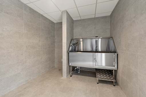 A stainless steel kitchen appliance is in a room with grey walls.