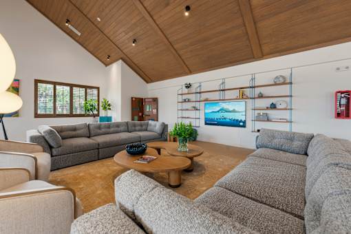 A living room with a grey couch and a wooden coffee table.