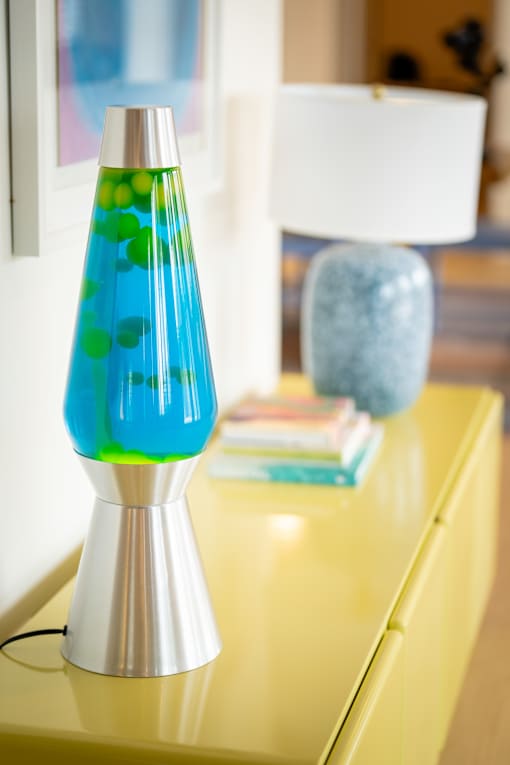 A blue and green lamp on a yellow table.at The Teale New Haven Apartments, Melbourne, FL, 32904