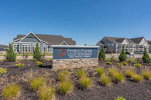 A sign for Pimlico Pointe Luxury Apartments is in front of some buildings.