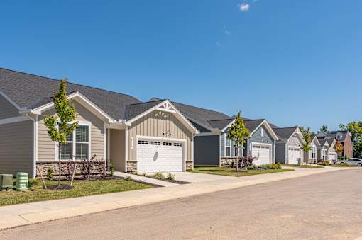 A row of houses with a clear blue sky above them.