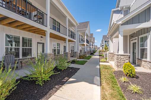A row of houses with a walkway in between.