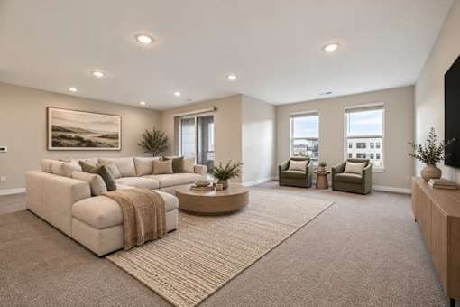 A living room with a large sectional sofa and a coffee table.