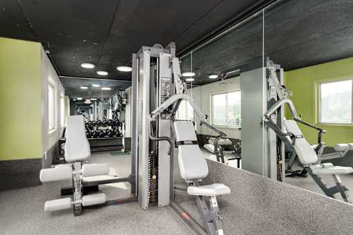 A gym with a variety of equipment including a leg press machine.
