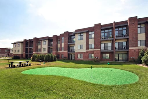 Putting green at Living room at Southfield MI Apartments | 42 West Apartments in Southfield Michigan