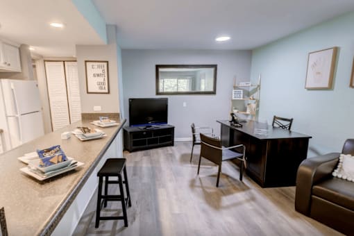 A kitchen with a bar area and a couch.