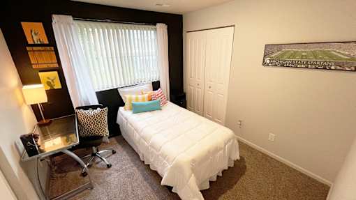 a small bedroom with a bed and a window