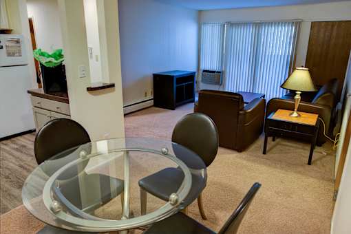 a living room with a glass table and a couch