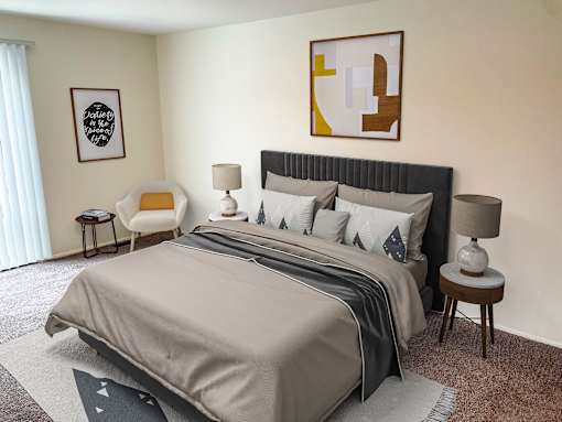 a bedroom with a large bed and a painting on the wall